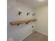 Functional laundry room with wood shelves and an accent wall at 7532 Gold Rush Ct, Camby, IN 46113