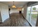 Spacious living room area with wood flooring, fireplace, and sliding glass doors to backyard at 7532 Gold Rush Ct, Camby, IN 46113