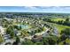 An aerial view of a home near a pond, in a neighborhood with green lawns and mature trees at 8380 Kolven Dr, Avon, IN 46123
