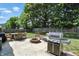 Landscaped backyard with a patio, fire pit, grill and plenty of space for entertaining at 8380 Kolven Dr, Avon, IN 46123