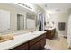 Bright bathroom with a double vanity, large mirror, and tiled flooring at 8380 Kolven Dr, Avon, IN 46123
