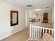 Bright upstairs hallway featuring neutral walls and carpet, leading to a seating area with comfortable chairs at 8380 Kolven Dr, Avon, IN 46123
