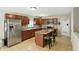 Well-lit kitchen features stainless steel appliances, granite countertops, and an island with bar seating at 8380 Kolven Dr, Avon, IN 46123