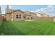 Spacious backyard features green grass, a garden area, and a partial view of neighboring homes at 958 Denton Ct, Westfield, IN 46074