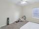 This bedroom has carpeted floors, a ceiling fan, and a window providing natural light at 958 Denton Ct, Westfield, IN 46074