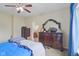 A well-lit bedroom enhanced by a ceiling fan and illuminated by natural light from its windows at 958 Denton Ct, Westfield, IN 46074