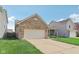 Single-story brick home with an attached garage and a neatly manicured lawn at 958 Denton Ct, Westfield, IN 46074