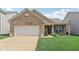 Charming single-story brick home featuring an attached garage and well-maintained front lawn at 958 Denton Ct, Westfield, IN 46074