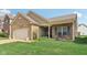 Well-kept single-story brick home with landscaped front yard and covered porch entrance at 958 Denton Ct, Westfield, IN 46074