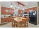 Kitchen featuring wooden cabinets, black appliances, and adjacent dining area with a wooden table and chairs at 958 Denton Ct, Westfield, IN 46074