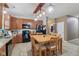 Kitchen with wooden cabinets, black appliances, with dining area featuring wooden table and chairs at 958 Denton Ct, Westfield, IN 46074