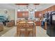 Updated kitchen with black appliances, a spacious wooden table, and a cozy seating area in the living room at 958 Denton Ct, Westfield, IN 46074