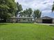 Charming single-story home featuring a spacious green lawn and detached garage at 105 Cottonwood Dr, Maxwell, IN 46154