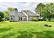 Lush green backyard with a fire pit, offering a serene outdoor space adjacent to the house at 10548 Magenta Dr, Noblesville, IN 46060