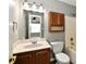 Bathroom showcasing a single vanity, a toilet, a tub-shower combo and a wood storage cabinet at 10548 Magenta Dr, Noblesville, IN 46060