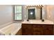 Bathroom with a large bathtub, double sink vanity, and modern lighting at 10548 Magenta Dr, Noblesville, IN 46060