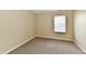 Neutral bedroom showcasing plush carpeting, a large window with blinds, and fresh, clean paint at 10548 Magenta Dr, Noblesville, IN 46060