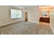 Bright bedroom featuring neutral walls, plush carpet, window, walk-in closet, and a glimpse into the attached bathroom at 10548 Magenta Dr, Noblesville, IN 46060