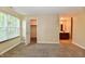Sunlit bedroom showcasing neutral walls, cozy carpeting, window, walk-in closet, and a peek into the attached bathroom at 10548 Magenta Dr, Noblesville, IN 46060