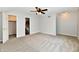 Inviting bedroom featuring a ceiling fan, warm carpeting, and a doorway leading to an adjacent bathroom at 10548 Magenta Dr, Noblesville, IN 46060