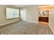 Carpeted bedroom with neutral walls, featuring a door and a glimpse of the ensuite bathroom at 10548 Magenta Dr, Noblesville, IN 46060