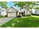Inviting single-story home featuring a lush green lawn and a classic brick design at 10548 Magenta Dr, Noblesville, IN 46060