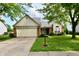 Charming single-story home features a two-car garage, brick accents, and a well-manicured front yard at 10548 Magenta Dr, Noblesville, IN 46060
