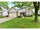 Cozy single-level home with a green lawn, attached garage, and decorative landscaping enhancing curb appeal at 10548 Magenta Dr, Noblesville, IN 46060