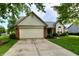 Attractive one-story home with brick and siding exterior, a two-car garage, and a neatly landscaped front yard at 10548 Magenta Dr, Noblesville, IN 46060