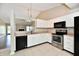 Kitchen with stainless steel appliances, white cabinets, and open access to a living space at 10548 Magenta Dr, Noblesville, IN 46060