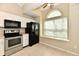 Clean kitchen with white cabinets, stainless steel appliances, and a black refrigerator at 10548 Magenta Dr, Noblesville, IN 46060