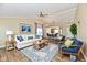 Stylish living room with vaulted ceilings, wood-look flooring, modern furniture, and ample natural light at 10548 Magenta Dr, Noblesville, IN 46060