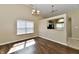 Bright living room featuring hardwood floors, large window, and modern lighting fixtures at 10548 Magenta Dr, Noblesville, IN 46060
