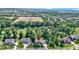 An aerial view of houses in a green neighborhood with a golf course shown in the background at 10585 Golden Bear Way, Noblesville, IN 46060