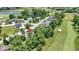 Beautiful aerial view of houses on a golf course surrounded by lush greenery and a pond at 10585 Golden Bear Way, Noblesville, IN 46060