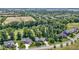 An aerial view of houses in a green neighborhood with a golf course shown in the background at 10585 Golden Bear Way, Noblesville, IN 46060