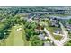 Overhead shot of a residence backing onto a golf course, boasting mature trees and serene neighborhood at 10585 Golden Bear Way, Noblesville, IN 46060