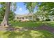Picturesque backyard view with mature trees and manicured lawn at 10585 Golden Bear Way, Noblesville, IN 46060