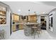 Basement bar features granite counters, wine fridge, pendant lighting, and a seamless flow to the rooms nearby at 10585 Golden Bear Way, Noblesville, IN 46060