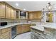 Charming basement bar featuring custom cabinetry, mini-fridge, and bar seating, perfect for entertaining guests at 10585 Golden Bear Way, Noblesville, IN 46060