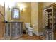 Charming powder room featuring rustic vanity, decorative wall texture, and beautiful hardwood flooring at 10585 Golden Bear Way, Noblesville, IN 46060