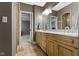 Bright bathroom featuring a double vanity, granite countertops, and tiled flooring at 10585 Golden Bear Way, Noblesville, IN 46060