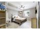 Comfortable bedroom featuring a double bed, desk, ceiling fan, and natural light at 10585 Golden Bear Way, Noblesville, IN 46060