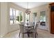Cozy breakfast nook featuring backyard views, a modern chandelier, and seating for four at 10585 Golden Bear Way, Noblesville, IN 46060