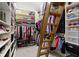 Walk-in closet featuring an extensive custom shelving system and a charming ladder for access at 10585 Golden Bear Way, Noblesville, IN 46060
