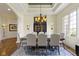 Bright dining room with a blue patterned rug, coffered ceilings, and a decorative chandelier at 10585 Golden Bear Way, Noblesville, IN 46060