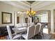 Bright dining area with a wooden table set, blue rug, and decorative sconces at 10585 Golden Bear Way, Noblesville, IN 46060