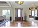An elegant foyer showcases hardwood floors, decorative columns, and a grand chandelier at 10585 Golden Bear Way, Noblesville, IN 46060