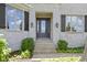 A welcoming front entrance featuring stone siding, a glass front door, and beautiful sconces at 10585 Golden Bear Way, Noblesville, IN 46060