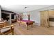 Entertaining game room with a pool table, bar area, and barn door at 10585 Golden Bear Way, Noblesville, IN 46060